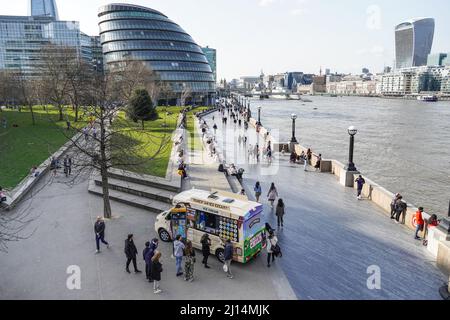 People enjoying sunny day at the Queen's Walk promenade in London, England United Kingdom UK Stock Photo