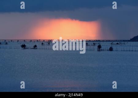 heavy rain clouds dark but there is also the light of the sun shining Stock Photo