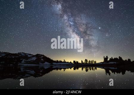The Milky Way galaxy and stars over Emerald Lake in Lassen Volcanic National Park, California Stock Photo