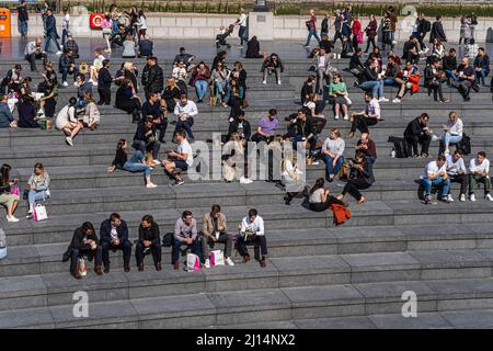 LONDON, UK. 22 March, 2022 . Lunchworkers enjoying the warm spring sunshine at the scoop on London Riverside as a warm weather spell is forecast with temperatures expected to reach highs of 20celsius in London and South East England. Credit: amer ghazzal/Alamy Live News Stock Photo
