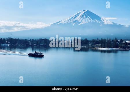 Mount Fuji and a boat on Lake Kawaguchi in Japan Stock Photo