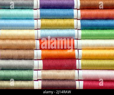 macro shot of rows of spools of multicolored threads for sewing. photo square Stock Photo