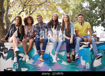 Their favorite city hangout. A group of friends chilling outdoors during the summer. Stock Photo