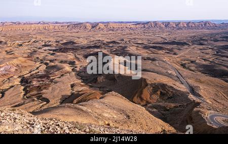 golden hour view of Hamakhtesh Hagadol the Large Crater in Negev Desert in Israel from the Mt Har Avnon overlook showing the colorful geology of the e Stock Photo