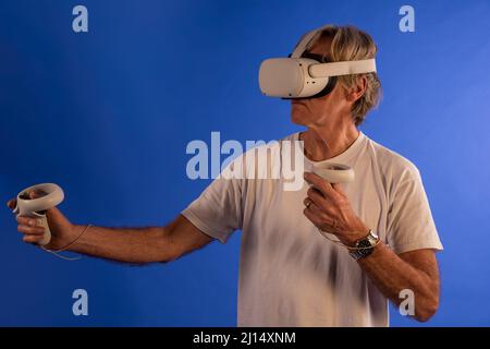 Old man using VR headset Stock Photo