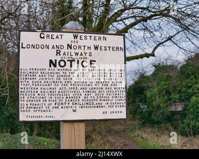 Dated February 1885, a sign from Great Western Railways and London and North Western Railways warns against trespass on their property Stock Photo