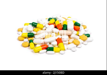 Pile of multi coloured pills, tablets and capsules on pure white background with space for copy. Multi colored Stock Photo