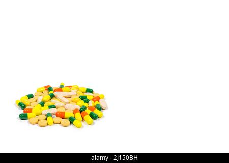 Pile of multi coloured pills, tablets and capsules on pure white background with space for copy. Multi colored Stock Photo
