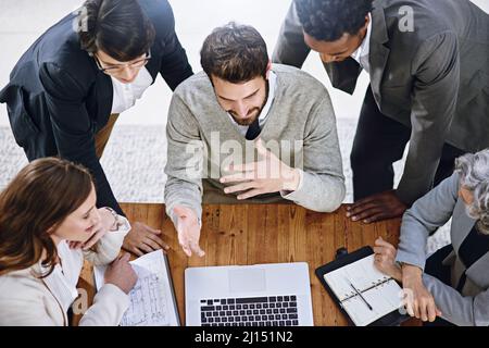 Working toward their shared goal. High angle shot of a group of businesspeople having a meeting in an office. Stock Photo