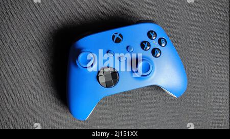 Blue game controller isolated on black surface Stock Photo