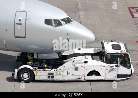 aircraft on pushback at international airport Stock Photo