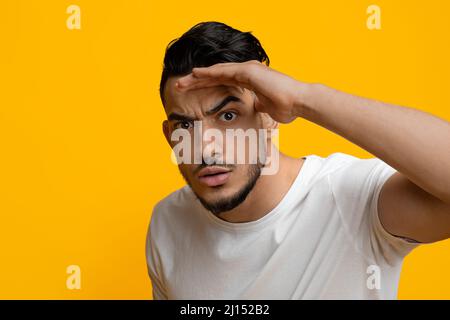 Confused guy holding hand by forehead and looking at camera Stock Photo