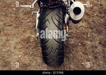 Wheel of a sports motorcycle. Rear wheel with exhaust pipe Stock Photo