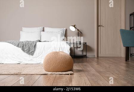 Beige pouf in interior of modern bedroom Stock Photo