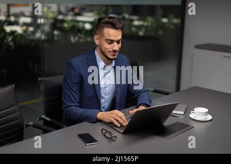 Handsome middle eastern entrepreneur working at modern office Stock Photo