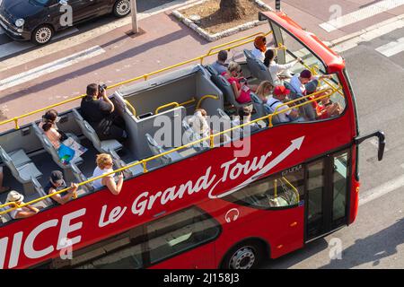 Nice, France - August 13, 2018: Tourists have a city tour on red double deck bus Stock Photo