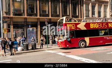 People take advantage of the unseasonable warm weather in front of the Nike store while shopping in Soho in New York on Friday, March 18, 2022.  (© Richard B. Levine) Stock Photo