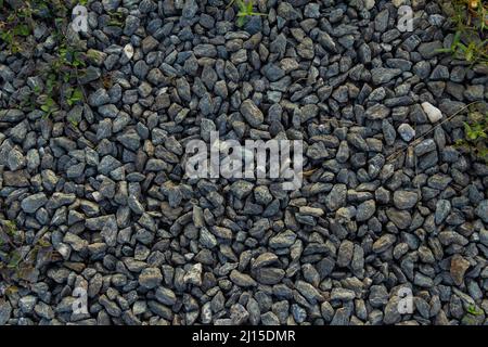 Goiânia, Goias, Brazil – March 22, 2022: The texture pattern of several scattered gravels covering the ground. Stock Photo