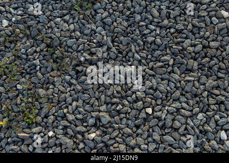 Goiânia, Goias, Brazil – March 22, 2022: The texture pattern of several scattered gravels covering the ground. Stock Photo