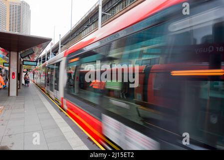 A blurred image of a Sydney Light Rail tram as it moves away from the platform at Circular Quay in central Sydney, New South Wales, Australia Stock Photo