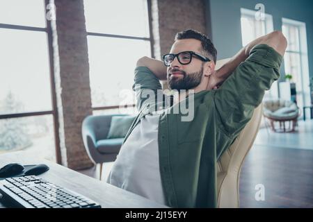 Photo of smiling guy expert end debugging website secure optimization hands head sit desktop in modern loft workspace Stock Photo
