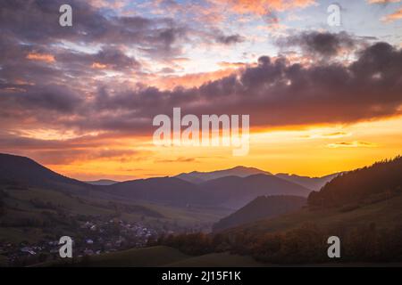 View of autumn rural landscape with colored clouds on a sky during a sunset. Stock Photo