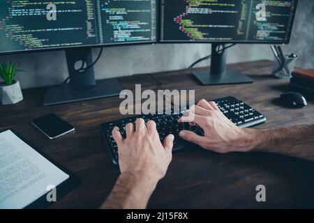 First point view cropped photo of designer guy typing start-up project web content development sit desk in modern loft workspace Stock Photo
