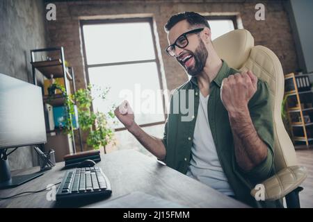 Profile side photo of delighted editor achieve debugging script server quality security raise fists-up sit desk in workspace Stock Photo