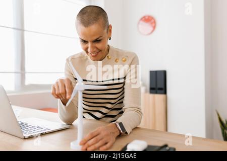 Thoughtful young female engineer working on renewable energy project at office Stock Photo