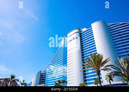 Facade of the luxury Jumeirah Beach Hotel against cloudy sky Stock Photo