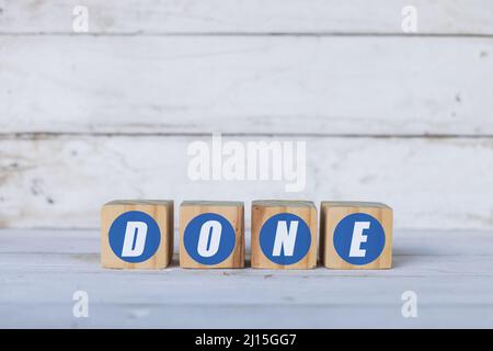done concept written on wooden cubes or blocks, on white wooden background. Stock Photo