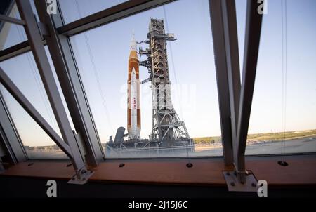 NASA’s Space Launch System (SLS) rocket with the Orion spacecraft aboard is seen through the windows of Firing Room One in the Rocco A. Petrone Launch Control Center atop a mobile launcher as it rolls out of High Bay 3 of the Vehicle Assembly Building for the first time to Launch Complex 39B, Thursday, March 17, 2022, at NASA’s Kennedy Space Center in Florida. Ahead of NASA’s Artemis I flight test, the fully stacked and integrated SLS rocket and Orion spacecraft will undergo a wet dress rehearsal at Launch Complex 39B to verify systems and practice countdown procedures for the first launch. Ph Stock Photo