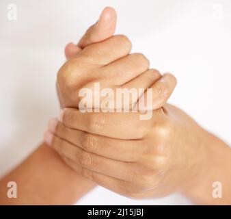 Keeping your hands moisturised is just as important. Cropped shot of an unrecognisable woman moisturising her hands. Stock Photo