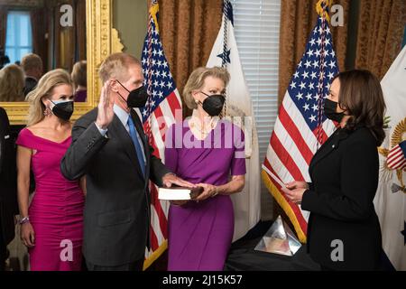 Former Senator Bill Nelson, is ceremonially sworn-in as the 14th NASA Administrator by Vice President Kamala Harris, as his wife, Grace Nelson, holds their family Bible, and his daughter, Nan Ellen Nelson, left, looks on, Monday, May 3, 2021, at the Ceremonial Office in the Old Executive Office Building in Washington. A moon rock collected by astronaut John Young during the Apollo 16 mission was on display and former NASA Administrators Jim Bridenstine (virtually on laptop) and Charles Bolden were also present. Photo Credit: (NASA/Aubrey Gemignani) Stock Photo