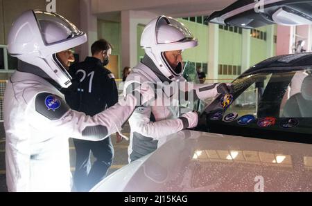 NASA astronauts Raja Chari, left, and Tom Marshburn, wearing SpaceX spacesuits, are seen as they place a sticker of the Crew-3 mission patch on the windshield of the vehicle that will take them to the launch pad as they prepare to depart the Neil  A. Armstrong Operations and Checkout Building for Launch Complex 39A during a dress rehearsal prior to the Crew-3 mission launch, Thursday, Oct. 28, 2021, at NASA’s Kennedy Space Center in Florida. NASA’s SpaceX Crew-3 mission is the third crew rotation mission of the SpaceX Crew Dragon spacecraft and Falcon 9 rocket to the International Space Statio Stock Photo