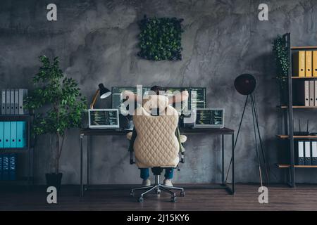 Rear back behind view of skilled guy working developing web project start-up intranet network at work place station indoors Stock Photo