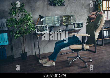 Profile side view portrait of attractive dreamy guy student developing web project start-up relax in armchair at workplace station indoors Stock Photo