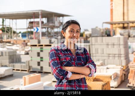 Woman worker posing at building materials warehouse Stock Photo