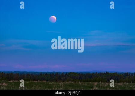 Red Moon over the Rocky Mountains, Canada Stock Photo