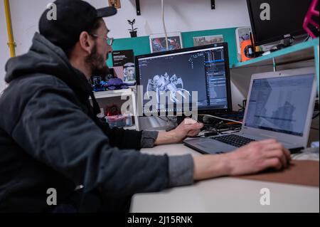 Man working on the design of a 3D printed robot Stock Photo