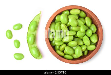 Green soy beans in wooden bowl isolated on white background. Top view. Stock Photo