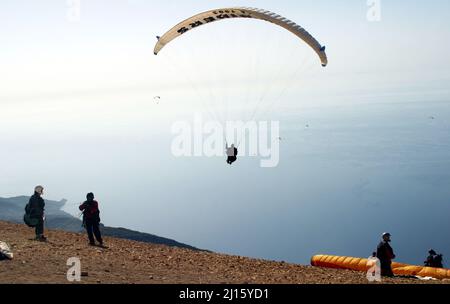FETHIYE, TURKEY - OCTOBER 22: Paraglider fly from Mount Babadag, October 22, 2003 in Fethiye, Turkey. Mount Babadag near Fethiye and a famous paragliding area in Turkey. Stock Photo