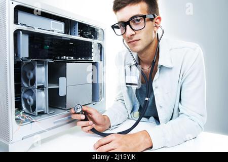 Fixing what needs to be fixed. Studio portrait of a young man working on a computer hard drive. Stock Photo