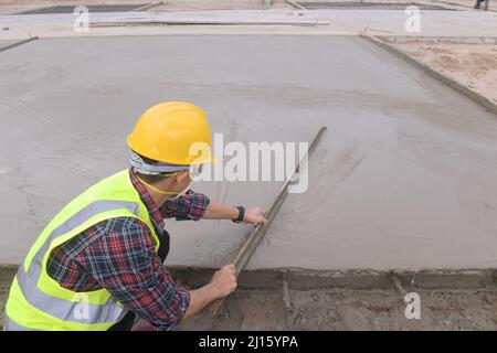 Cement Concrete Road Construction,Concrete pouring during commercial concreting floors of building Stock Photo
