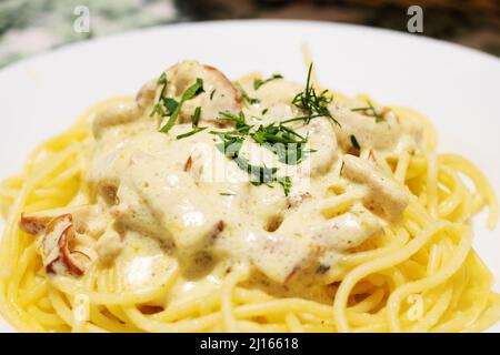 Pasta carbonara with cheese on a white plate Stock Photo