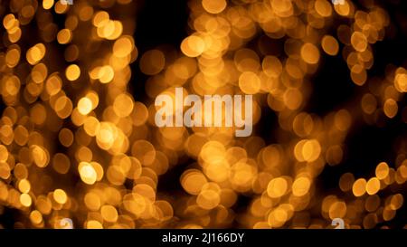 Garlands shot in blur. Backdrop of lights in dark. Lot of light bulbs are lit at festival. Texture cloud of lights. Stock Photo
