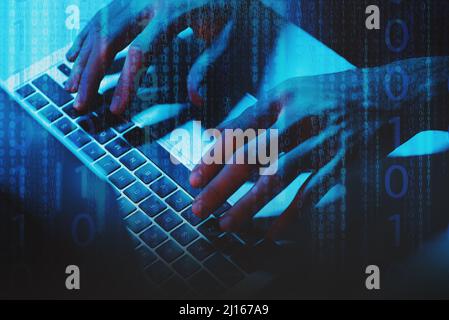 A man Using a laptop computer under blue light, one and zero digits on foreground layer. Stock Photo