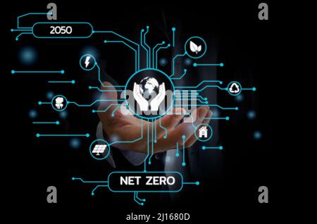 Businessman touching net zero save the eco world and reduce pollution virtual screen. virtual screen Business Technology Concept. Stock Photo