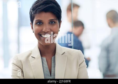 Shes young and goal oriented. Cropped portrait of a businesswoman standing in the office. Stock Photo