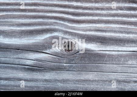 The surface of an old, brown, wooden board with a place from the branch, similar to the eye Stock Photo
